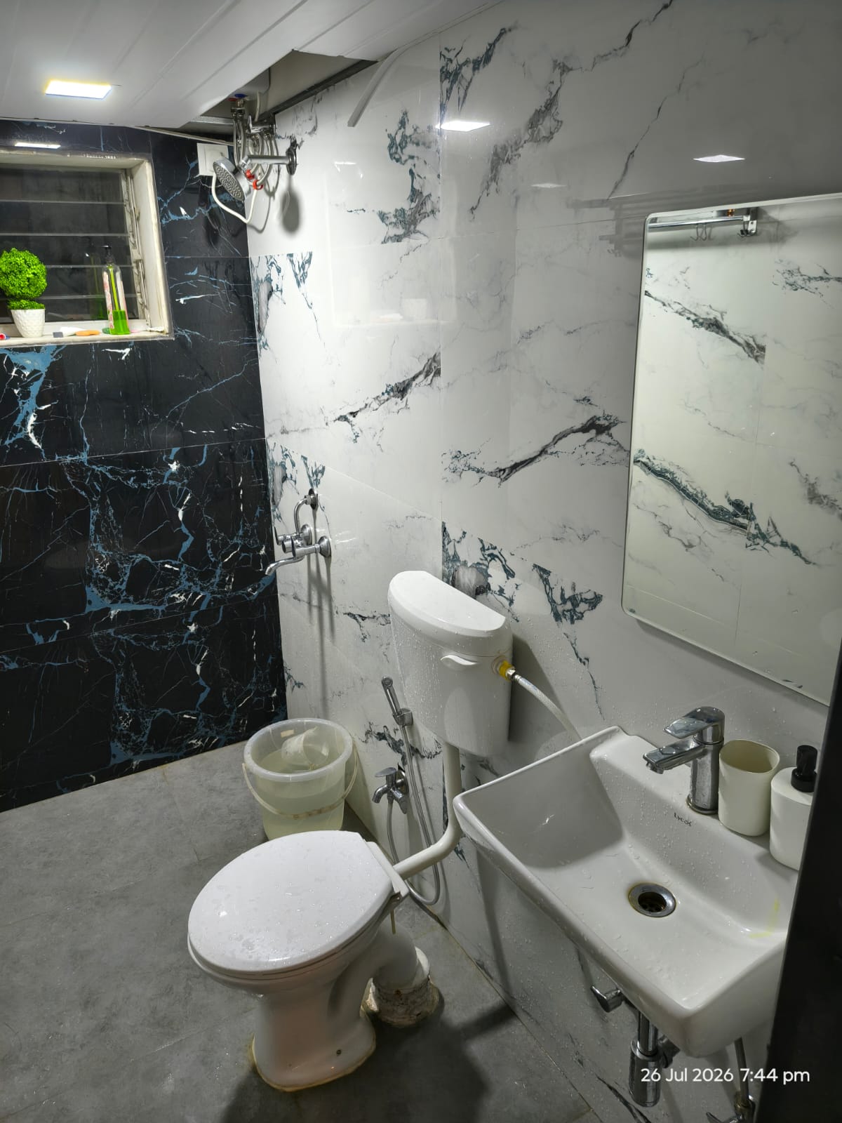 Modern marble bathroom with shower and hot water at Cabin in the Woods, Tungarli, Lonavala